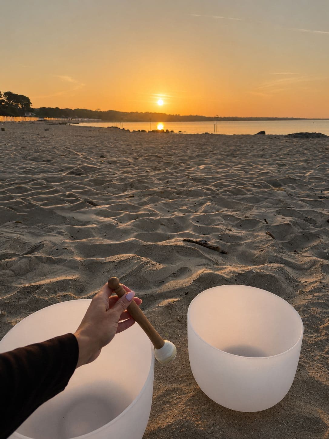 Sound bowl held at sunset on the beach at Mudeford